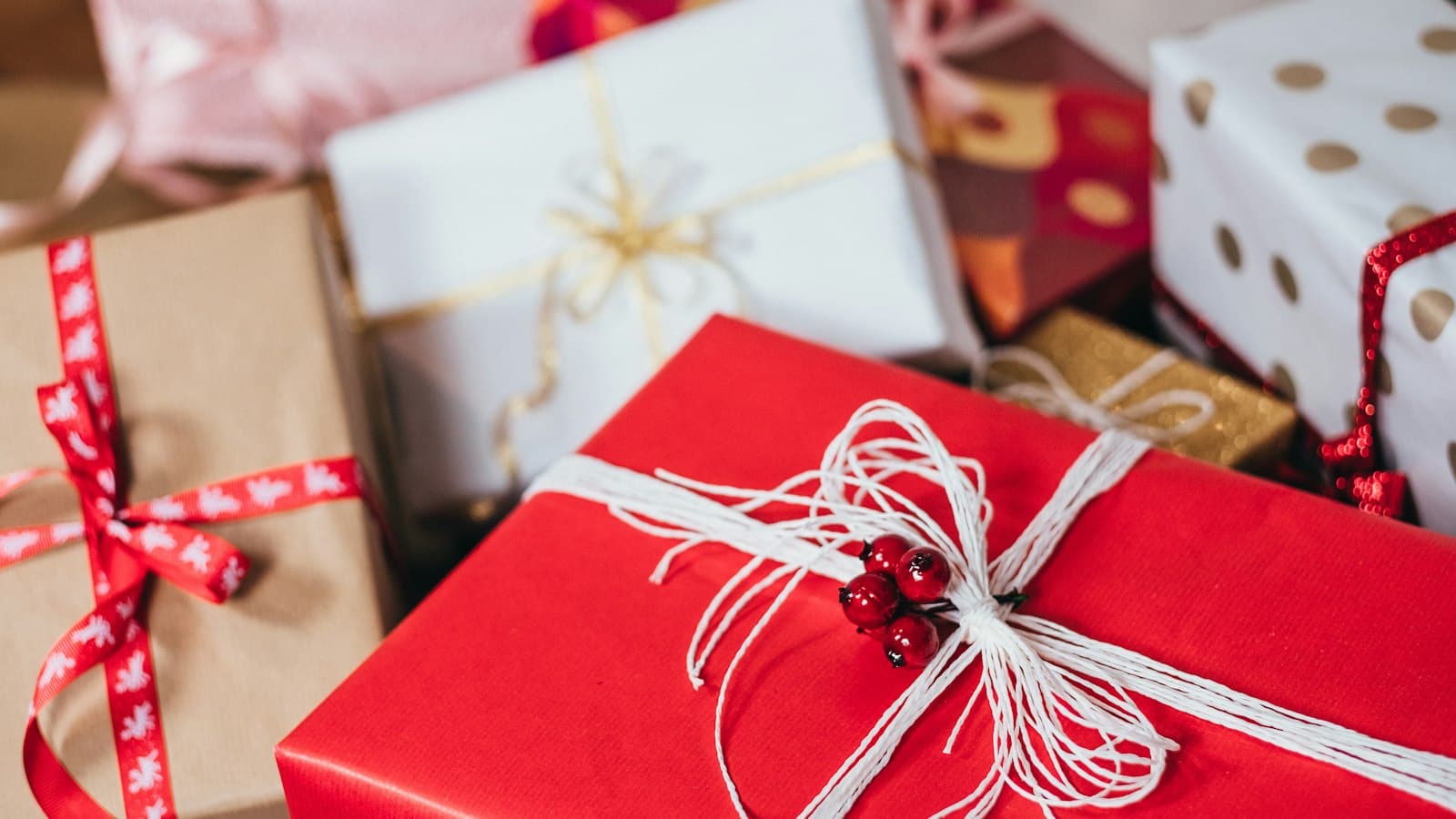 Wrapped holiday gifts and ribbon, illustrating December ecommerce gift season